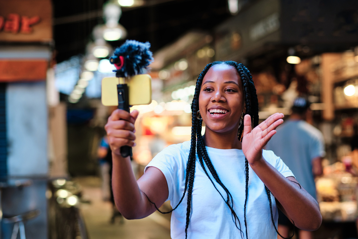 young gen z african american woman streaming live from local market